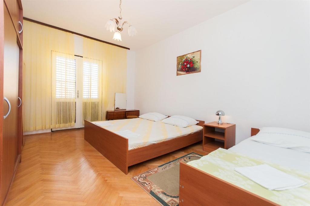 Postel nebo postele na pokoji v ubytování Apartment Slavko