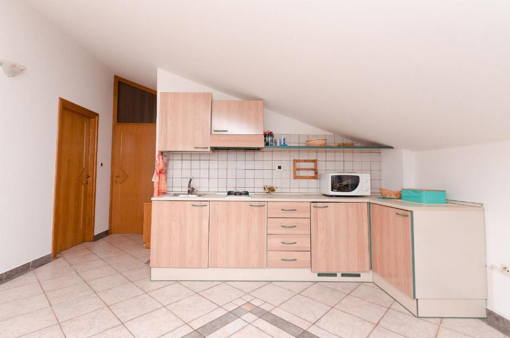 Kuchyň nebo kuchyňský kout v ubytování Apartments Milan
