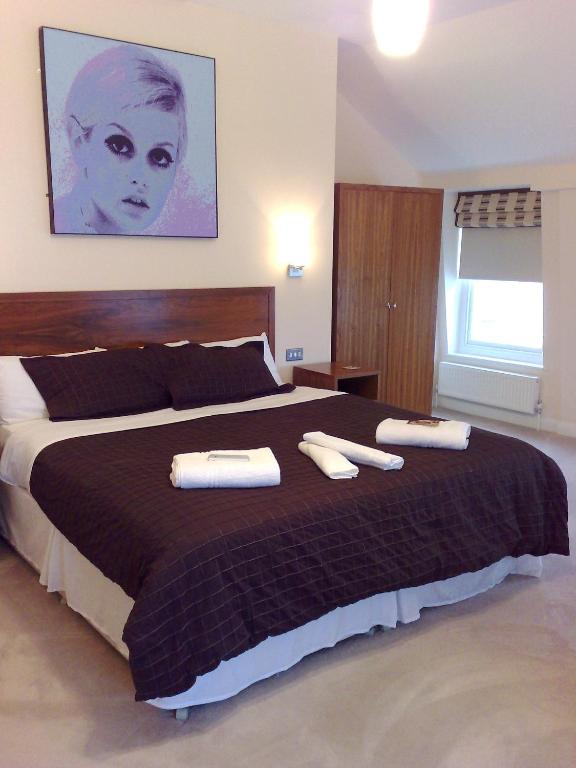 Postel nebo postele na pokoji v ubytování Legends Hotel