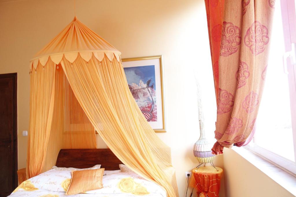 a bed with a canopy in a bedroom at Casa di Luce in Aghia Marina