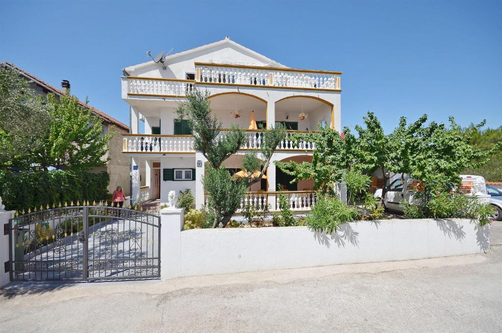 a house with a gate in front of it at Apartments Finka in Vodice