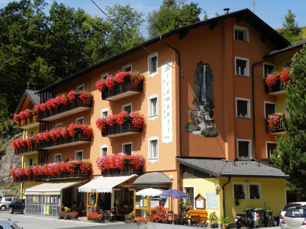 a building with flower boxes on the side of it at Hotel Miramonti in Bedollo