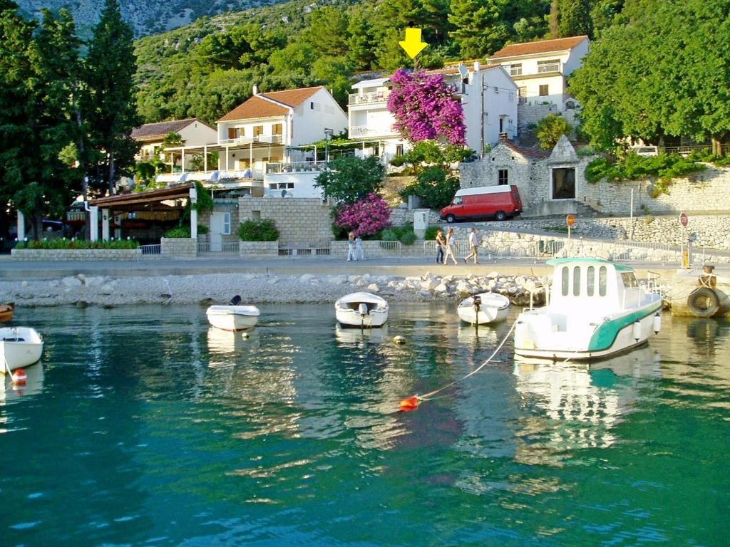 a group of boats in a body of water at Apartment Ksenija in Drvenik