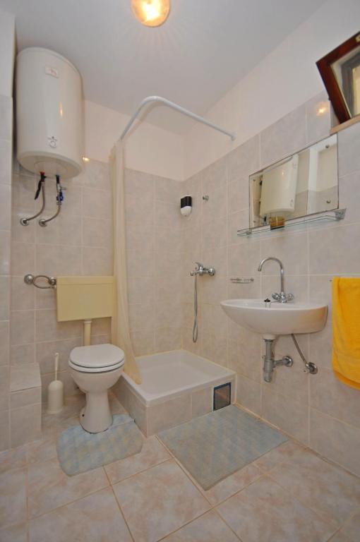 a bathroom with a toilet and a sink at Apartments Val in Vinišće