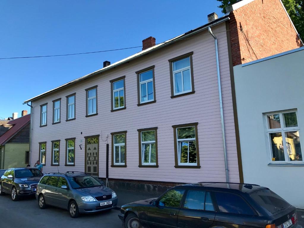 two cars parked in front of a building at Chelsea Karusselli 3 Apartment in Pärnu