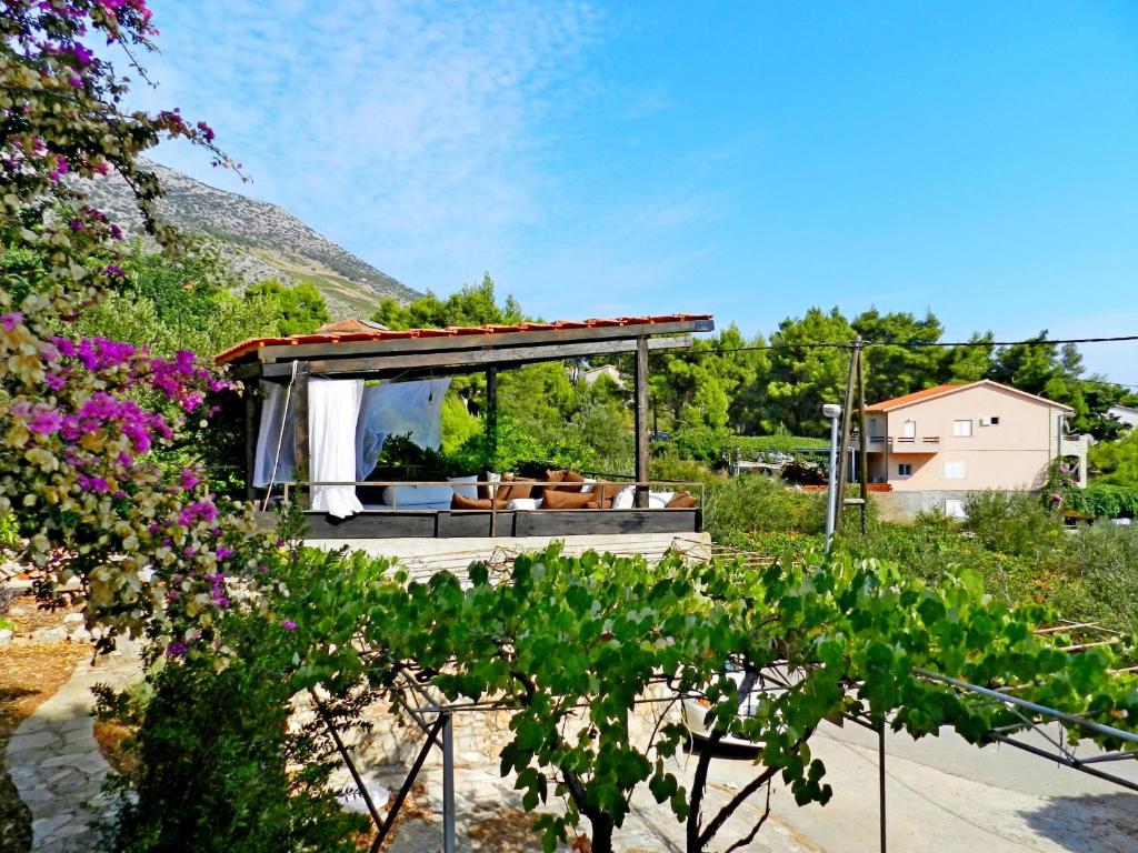 a house with a view of a garden at House Renato in Ivan Dolac