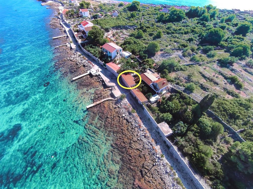 an aerial view of a beach with a house and the ocean at House Mislav II in Velike Kuknjare