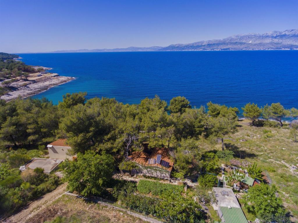 an aerial view of a house on the shore of a lake at House Fisherman in Postira