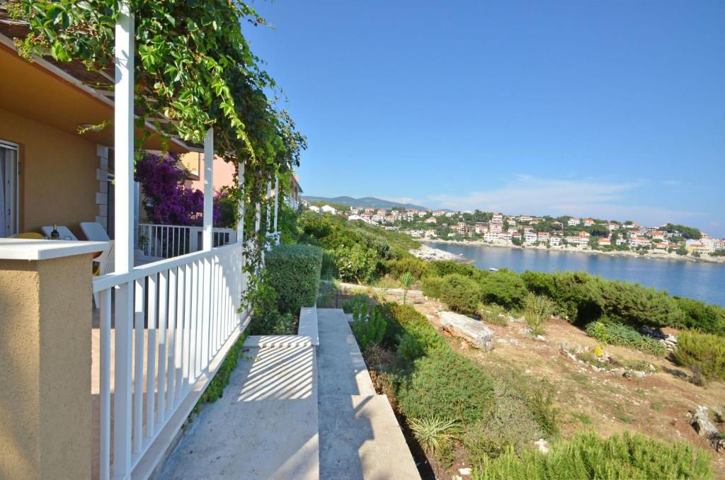a balcony of a house with a view of the water at House Julije in Zavalatica