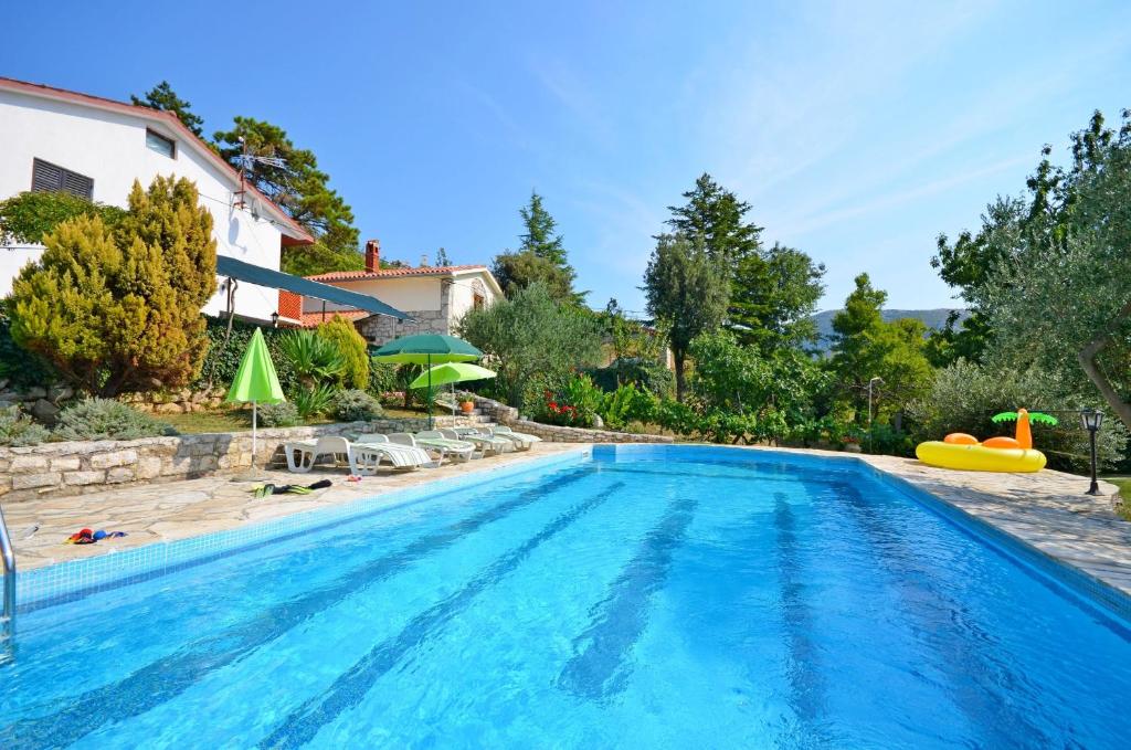 a large swimming pool with a pool toy and an inflatable at Apartment Josip in Plomin