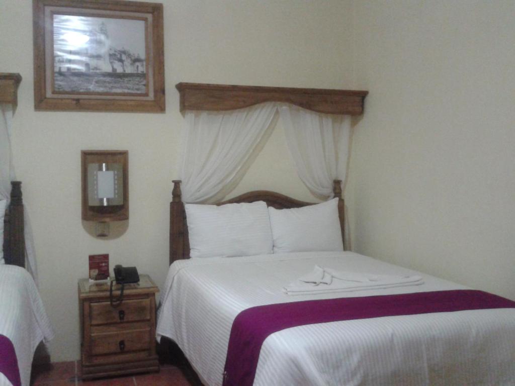 Postel nebo postele na pokoji v ubytování Hotel Tradicional