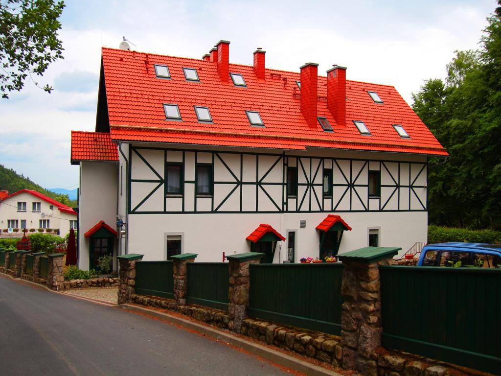 a large house with a red roof on a street at Dom Potok in Karpacz