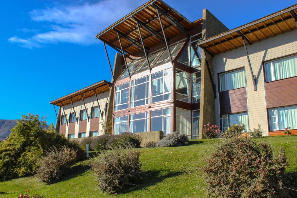 an exterior view of a large building with windows at Terrazas Del Calafate in El Calafate
