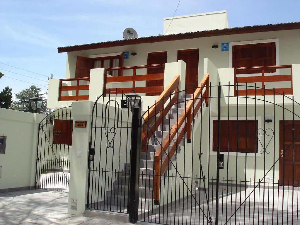 a house with a gate in front of a building at Posada Las Dunas in San Bernardo