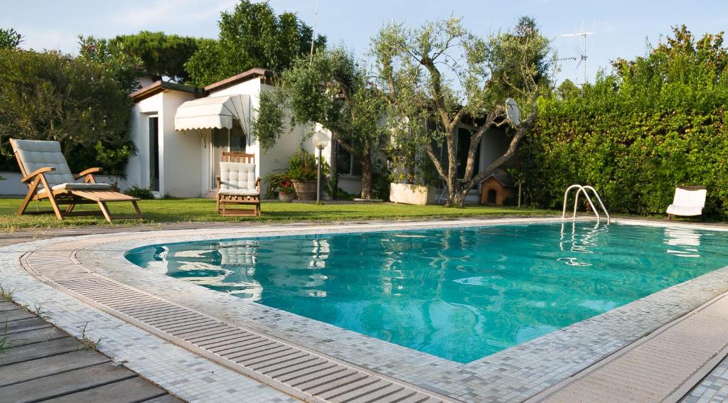 a swimming pool in front of a house at Casa Lupita in Terracina