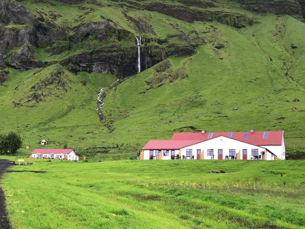 a small village on a hillside with houses at The Garage in Varmahlíð