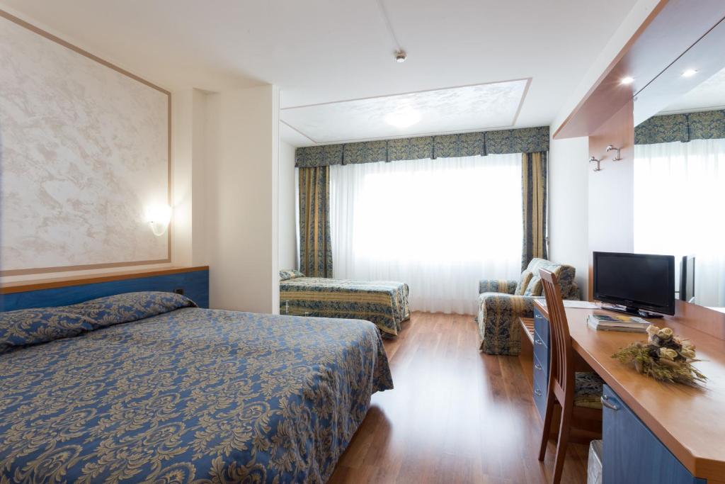 Postel nebo postele na pokoji v ubytování Hotel Airmotel