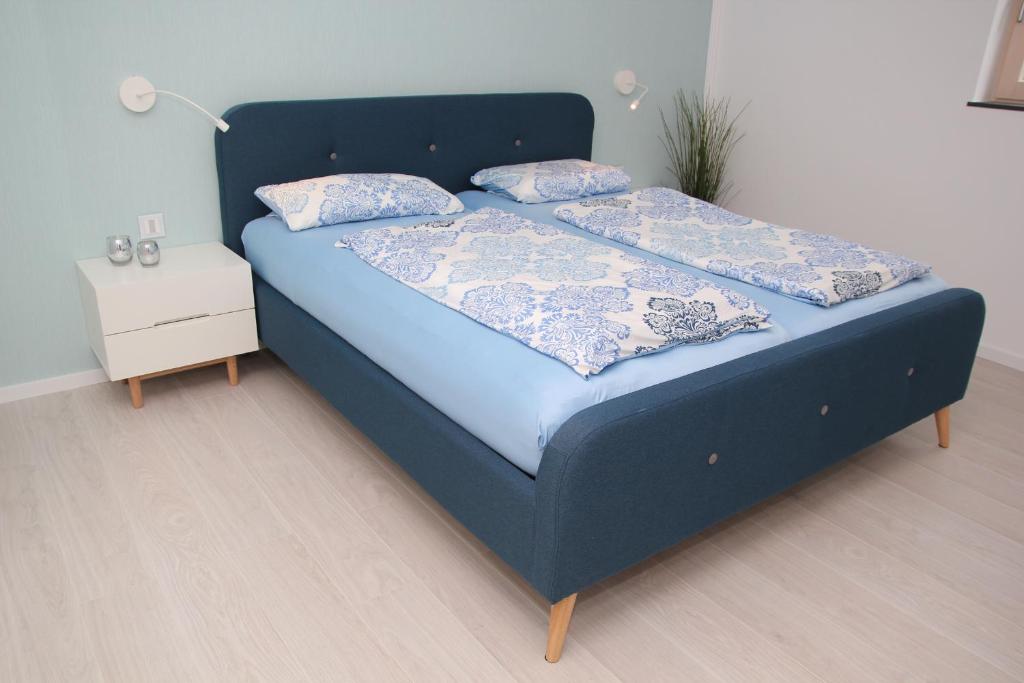 a blue bed with two pillows on it in a room at Jakob8 in Blieskastel