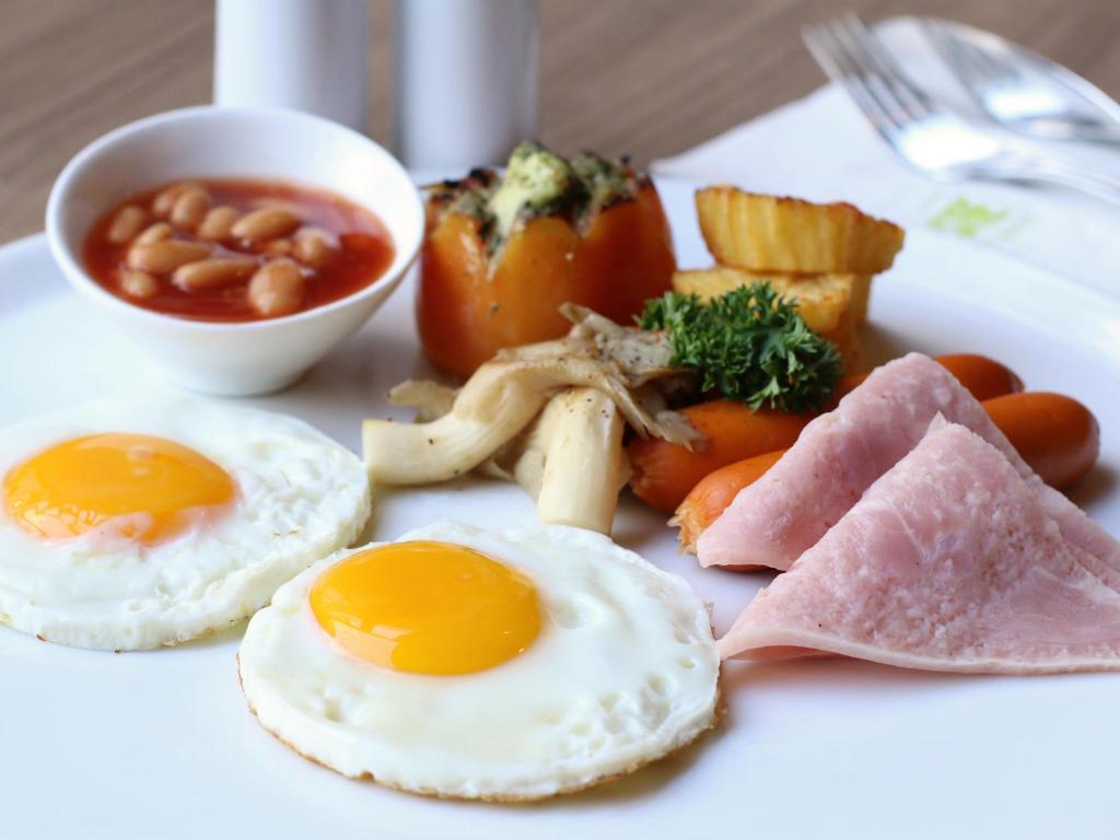 a plate of breakfast food with eggs and beans at Ibis Phuket Kata in Kata Beach