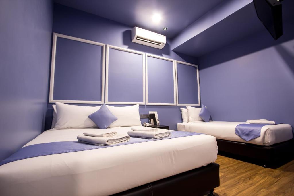 Postel nebo postele na pokoji v ubytování Bloommaze Boutique Hotel Puchong