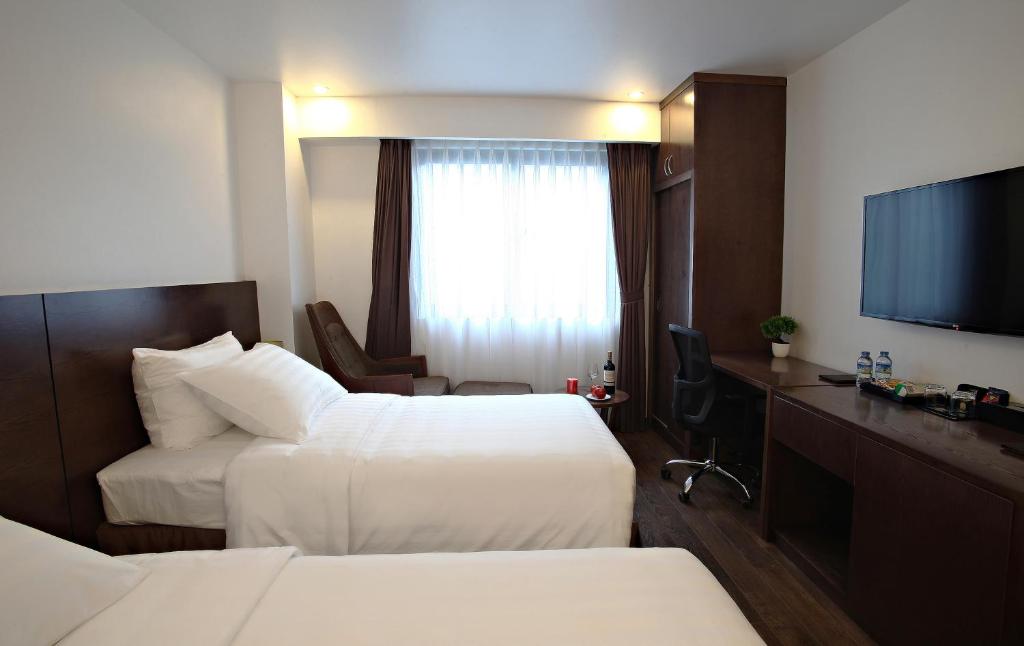 Postel nebo postele na pokoji v ubytování Inearth Hotel
