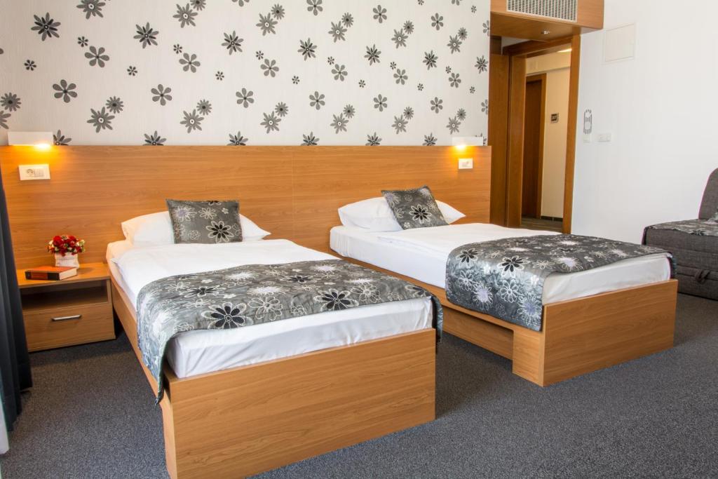 Postel nebo postele na pokoji v ubytování Hotel Delminivm