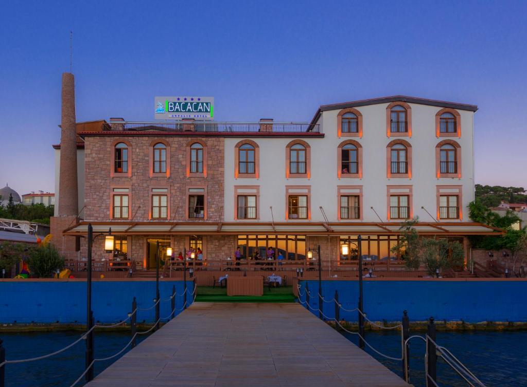 
a large building with a clock on the front of it at Bacacan Otel in Ayvalık
