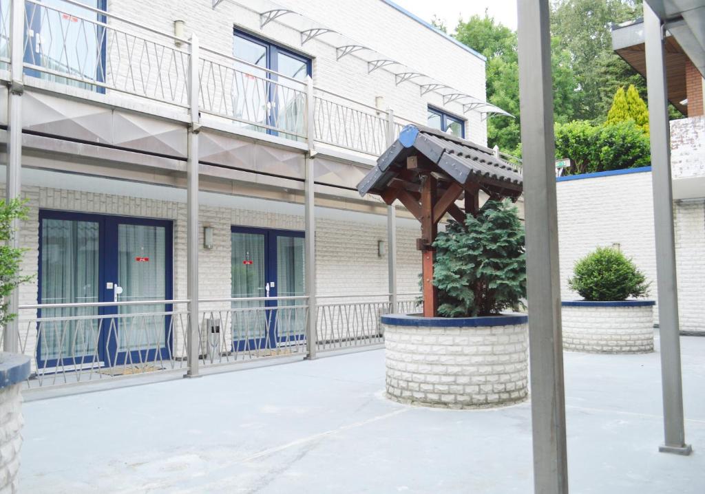 a view of a building with a wooden umbrella at Hotel B8 Voerde in Voerde