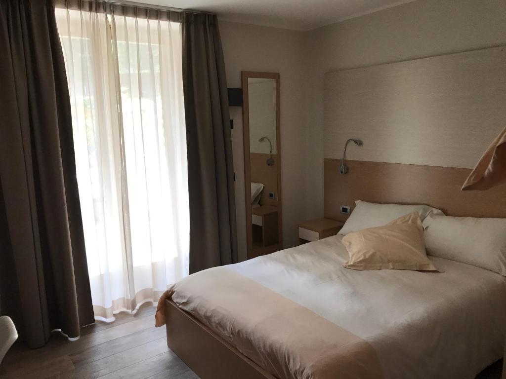 Postel nebo postele na pokoji v ubytování Hotel Le Cime