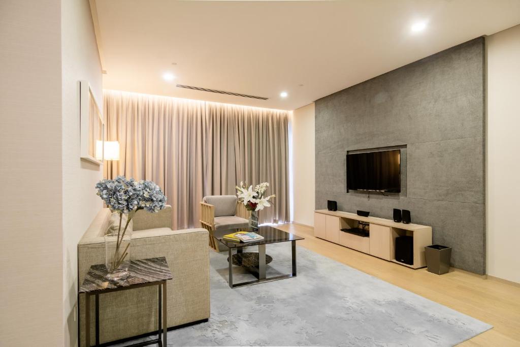 a living room with a couch and a tv at 188 Suites by NamaStay in Kuala Lumpur