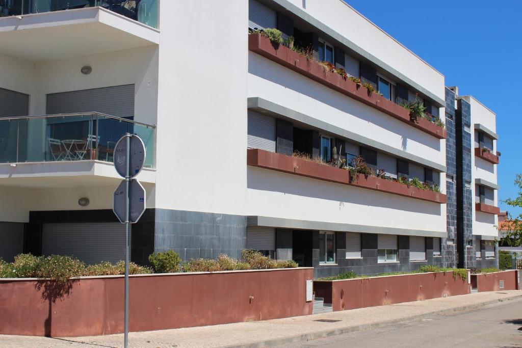 an apartment building with flower boxes on the balconies at Modern 1 bedrom apartment in Albufeira