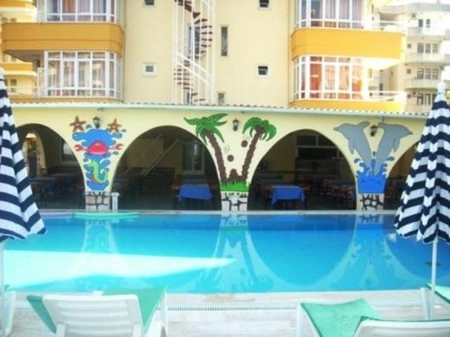 a swimming pool in front of a building at Best Alanya Hotel in Alanya