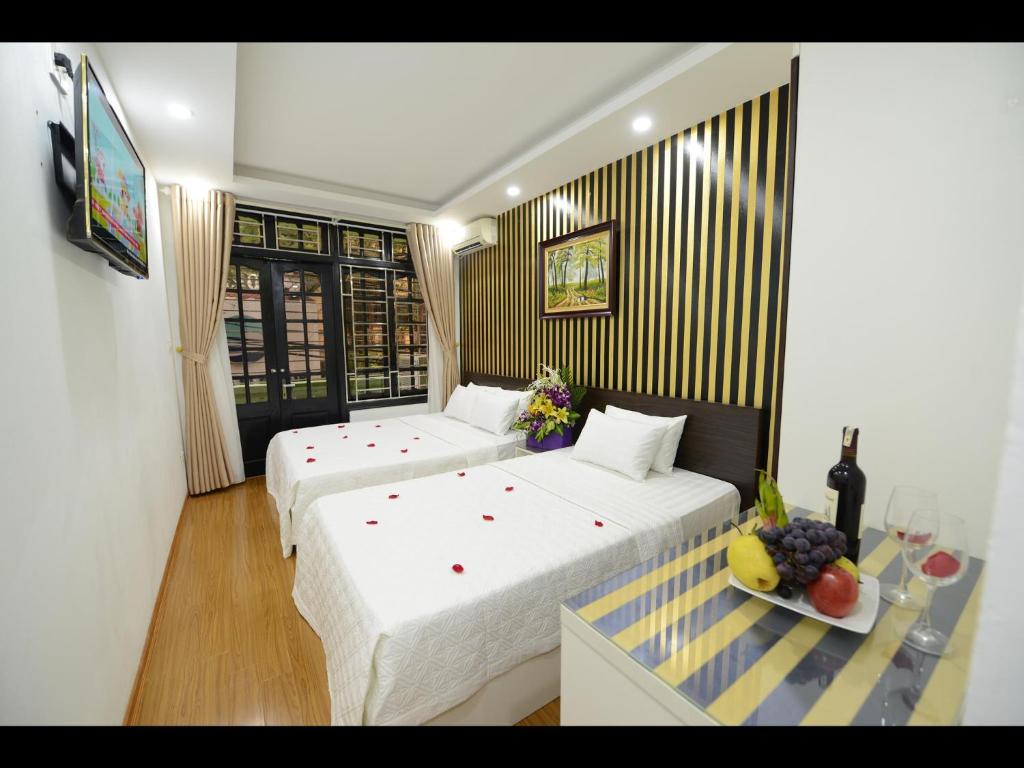 Postel nebo postele na pokoji v ubytování Hanoi Golden Hostel