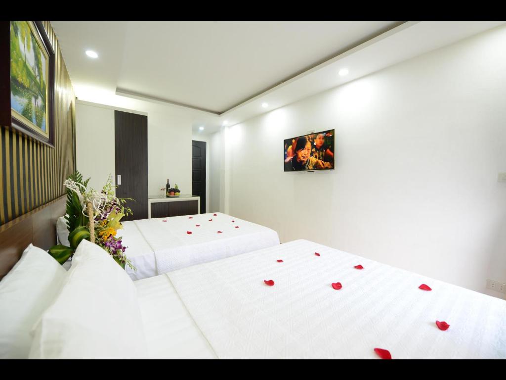 Postel nebo postele na pokoji v ubytování Hanoi Golden Hostel