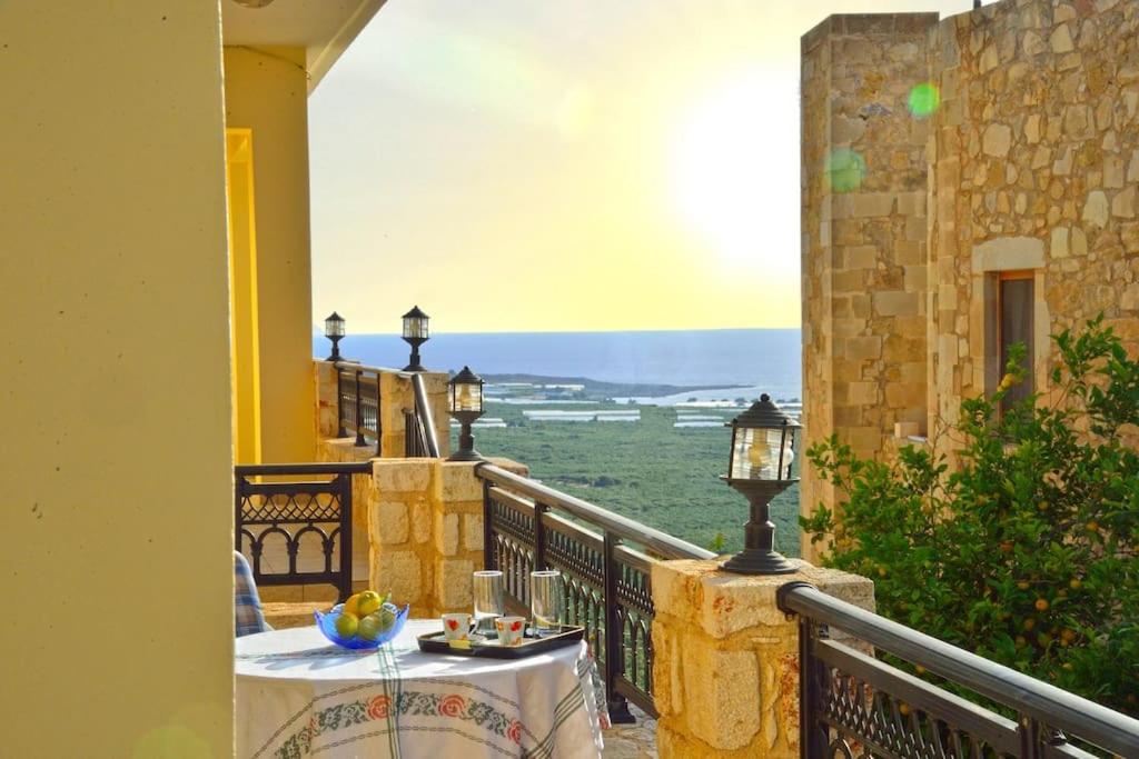 a table on a balcony with a view at Archontiko Ilias in Kavoúsion