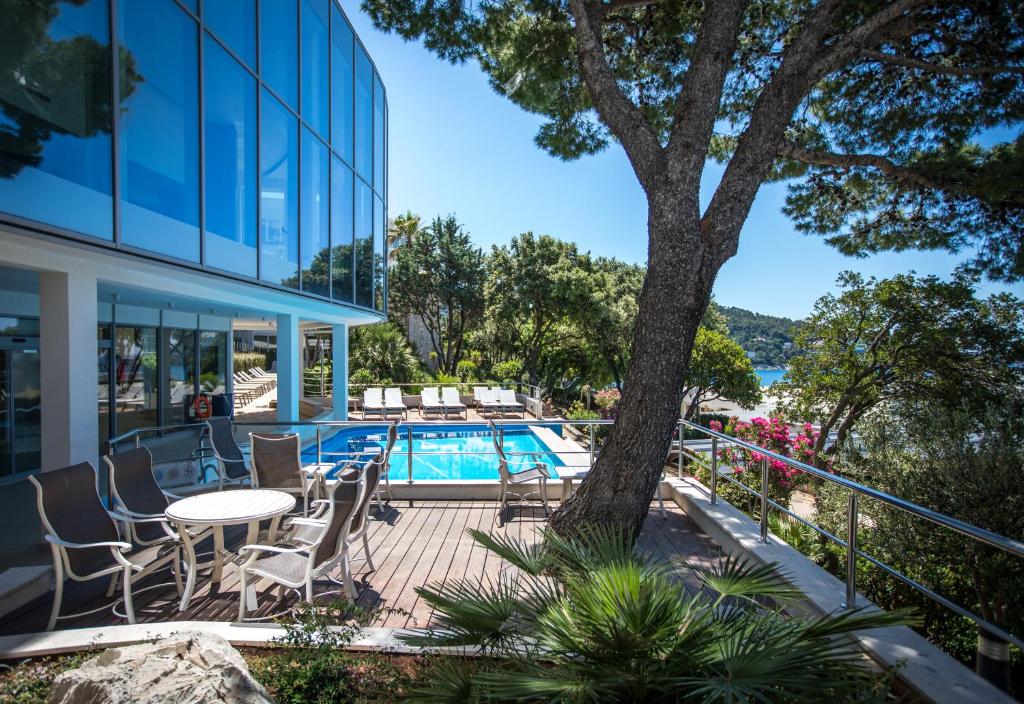 a patio with a table and chairs next to a building at Royal Neptun Hotel in Dubrovnik