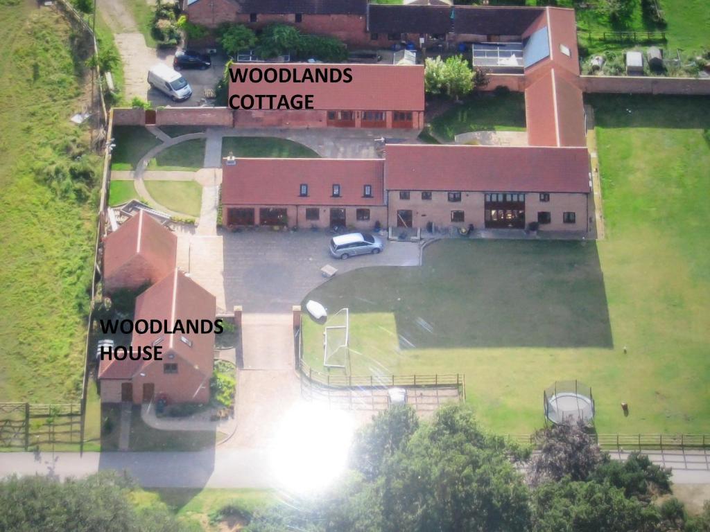 an aerial view of a school building with a parking lot at Woodlands Holiday Homes in South Clifton