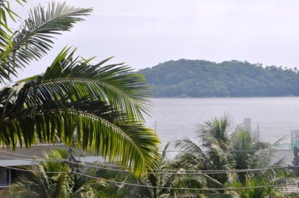 a view of a body of water with palm trees at Residencial Annabel APTO 02 in Bombinhas
