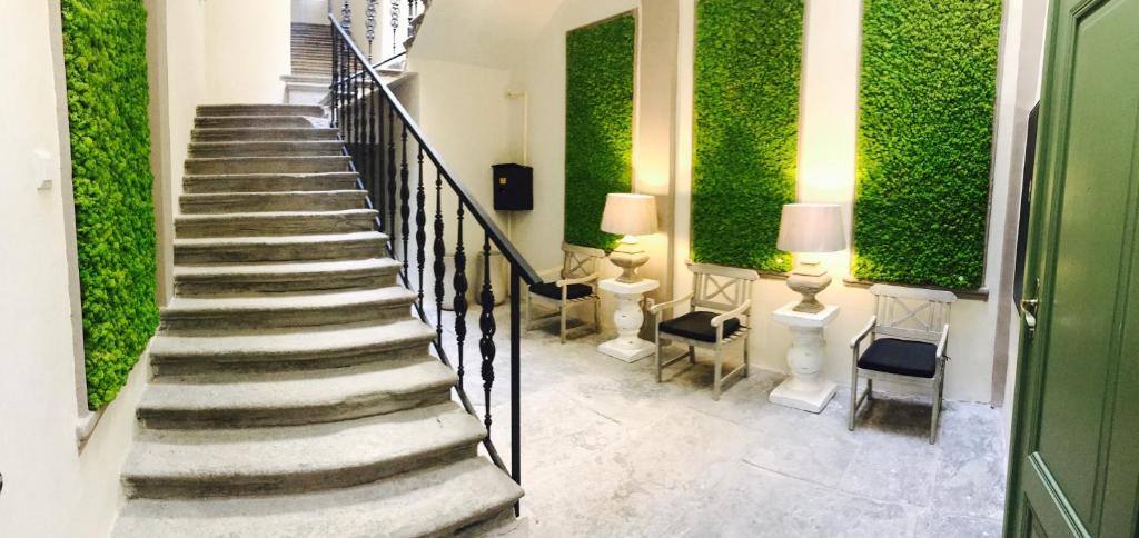 a staircase in a building with a green wall at H75 Apartments Kosice Centre in Košice