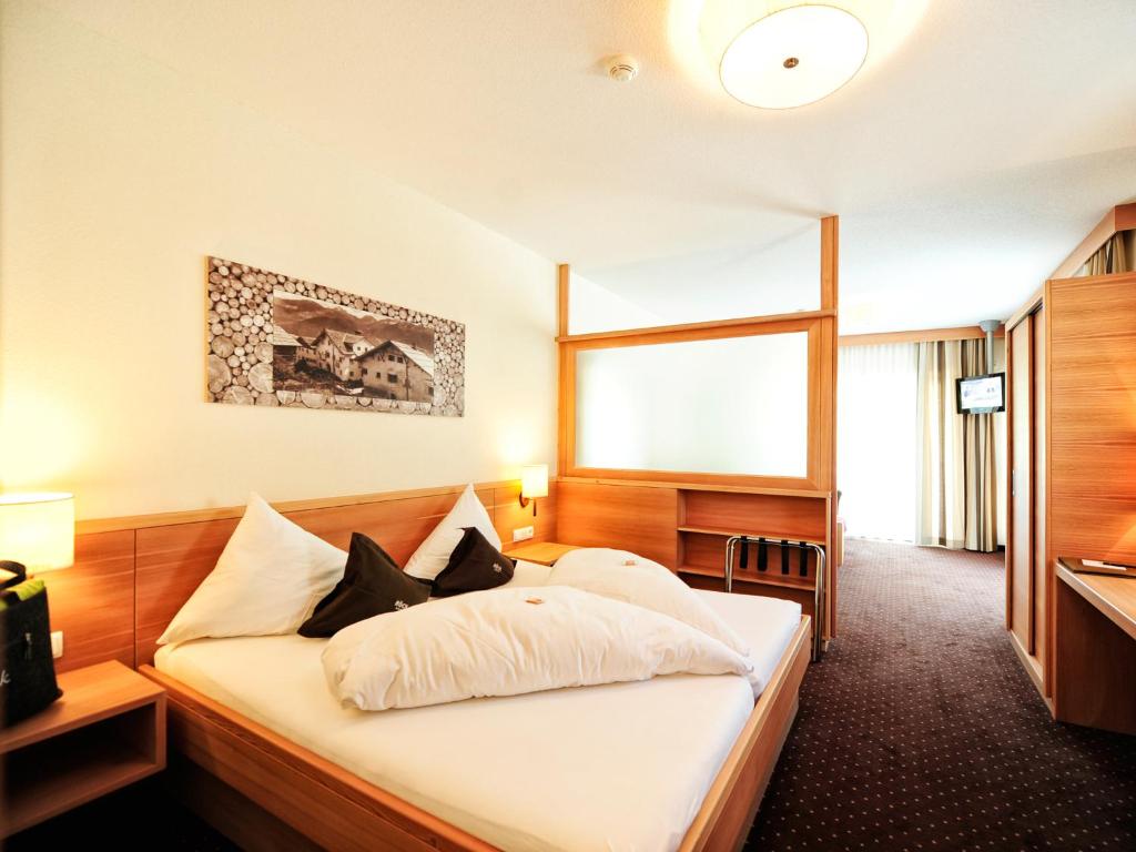 Postel nebo postele na pokoji v ubytování Hotel Röck Garni