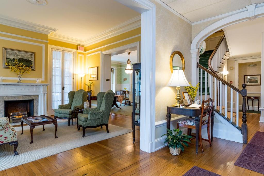 a living room with yellow walls and a fireplace at Stanton House Inn in Greenwich