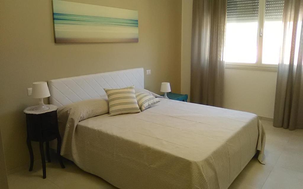 a bedroom with a large white bed with two pillows at Appartamento Stefania in Castro di Lecce