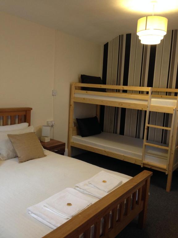 a bedroom with two bunk beds and a lamp at Rembrandt Guest House in Great Yarmouth