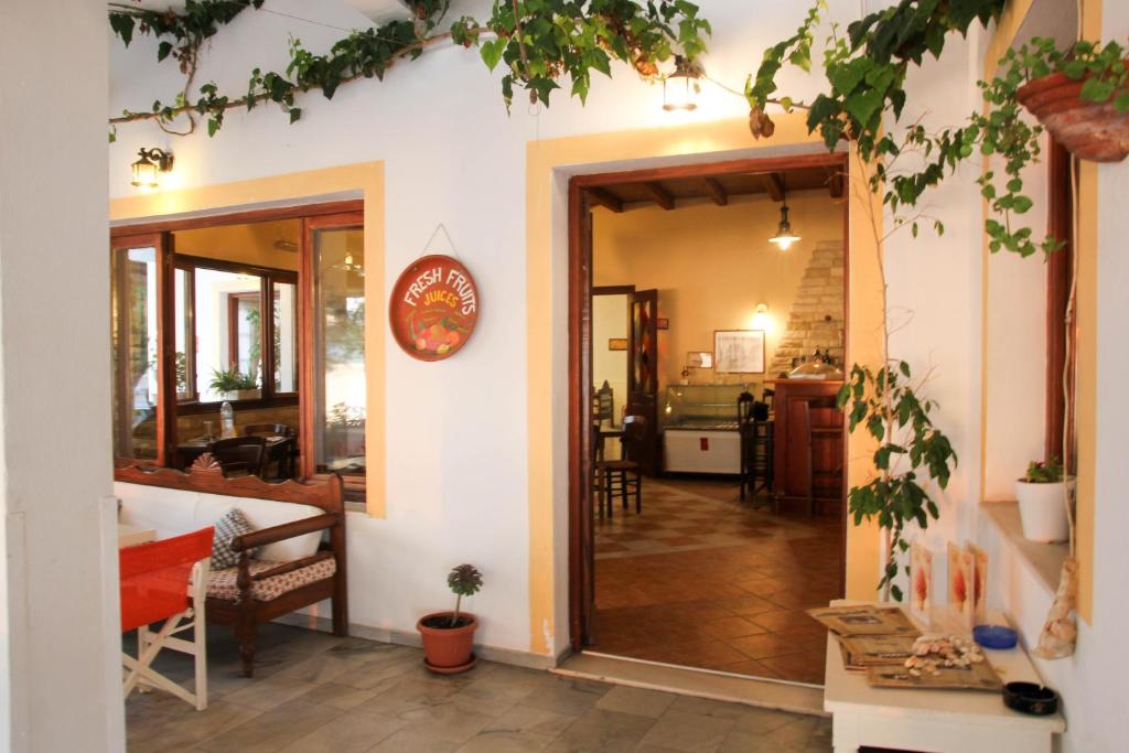 an open door into a living room with a kitchen at Hotel Zannet in Parikia