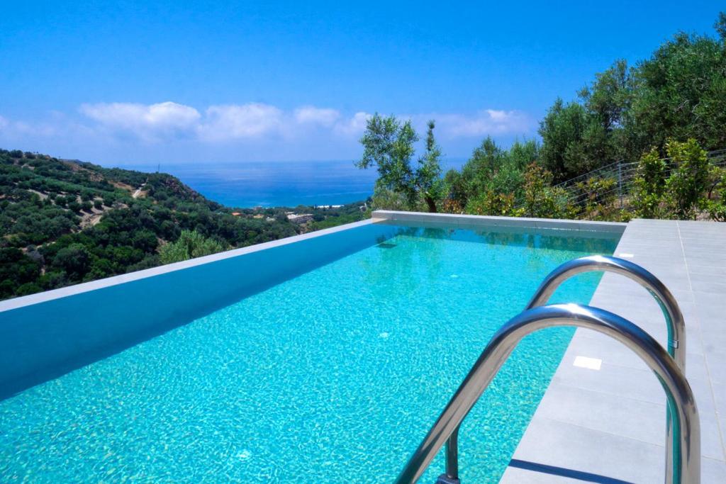 a swimming pool in a villa with a view at Villa Levande in Sfinárion