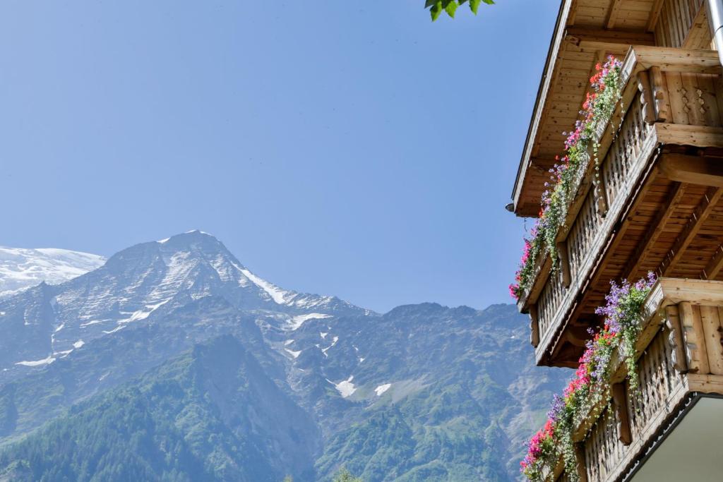 a mountain with flowers on the balconies of a building at Le Saint Antoine in Les Houches