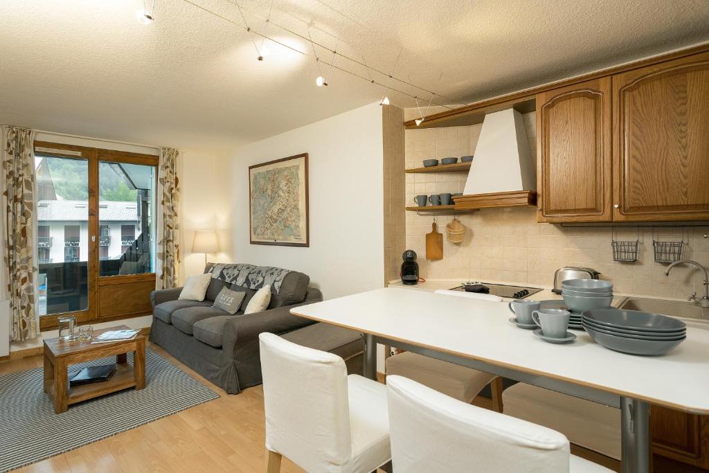 een keuken en een woonkamer met een bank en een tafel bij Apartment Balme 2 in Chamonix-Mont-Blanc