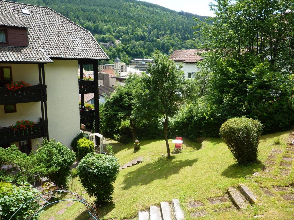 a view of a yard with a house and trees at Atina Hotel in Bad Wildbad