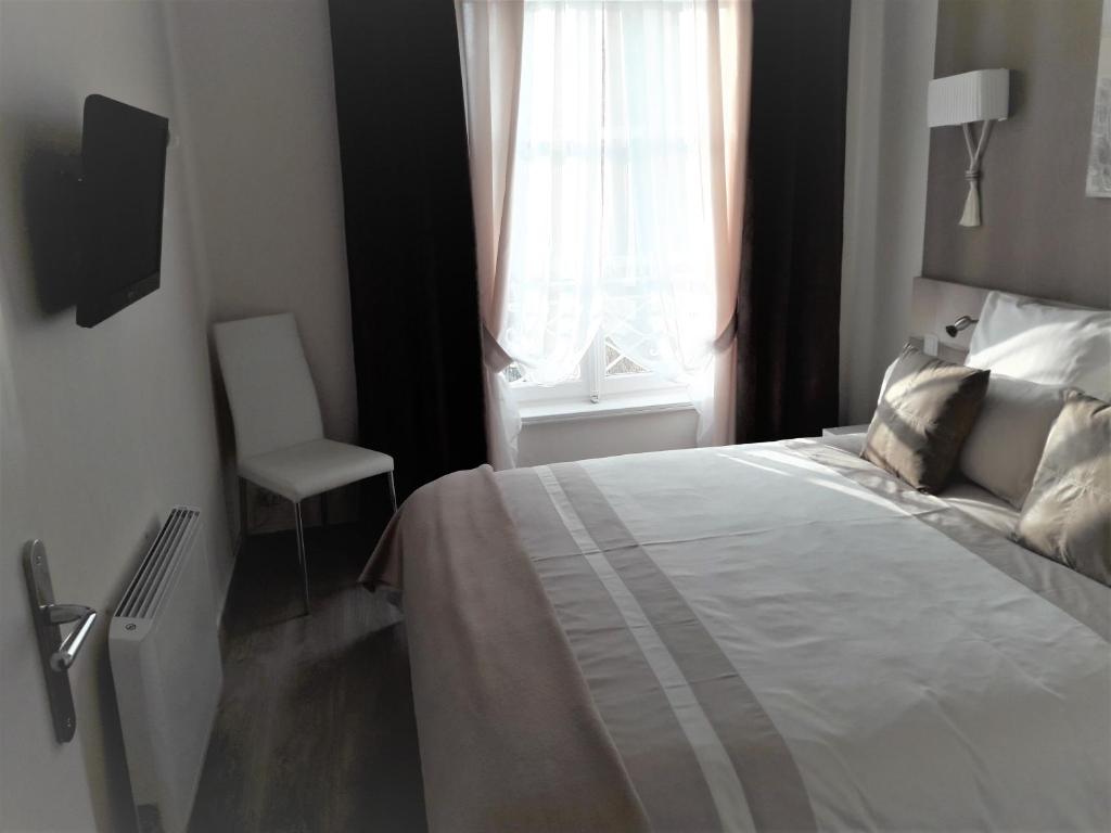 Postel nebo postele na pokoji v ubytování Chic En Ville