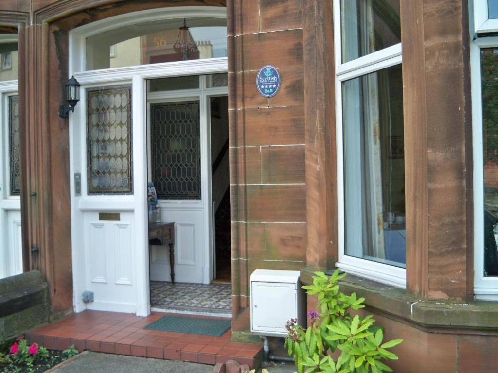 una puerta abierta de una casa con una computadora en el porche en The Conifers, en Edimburgo